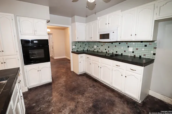 a view of a kitchen with microwave and cabinets
