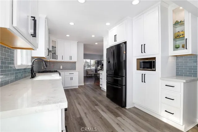 a kitchen with stainless steel appliances a refrigerator stove and oven