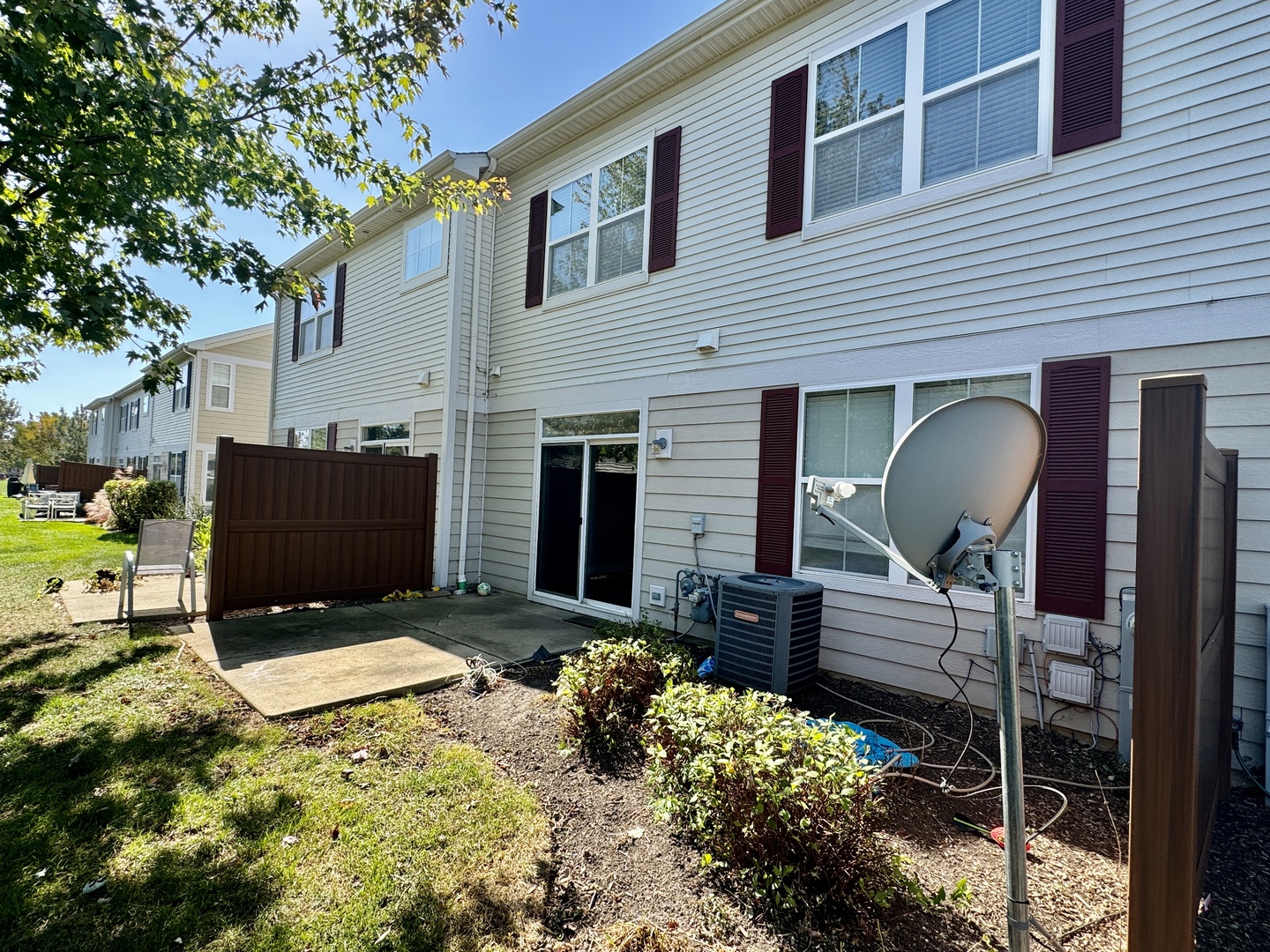 423 Acushnet Street, Unit 423 Elgin, IL 60124 - Photo 19 of 20 a view of backyard with a chair and potted plants