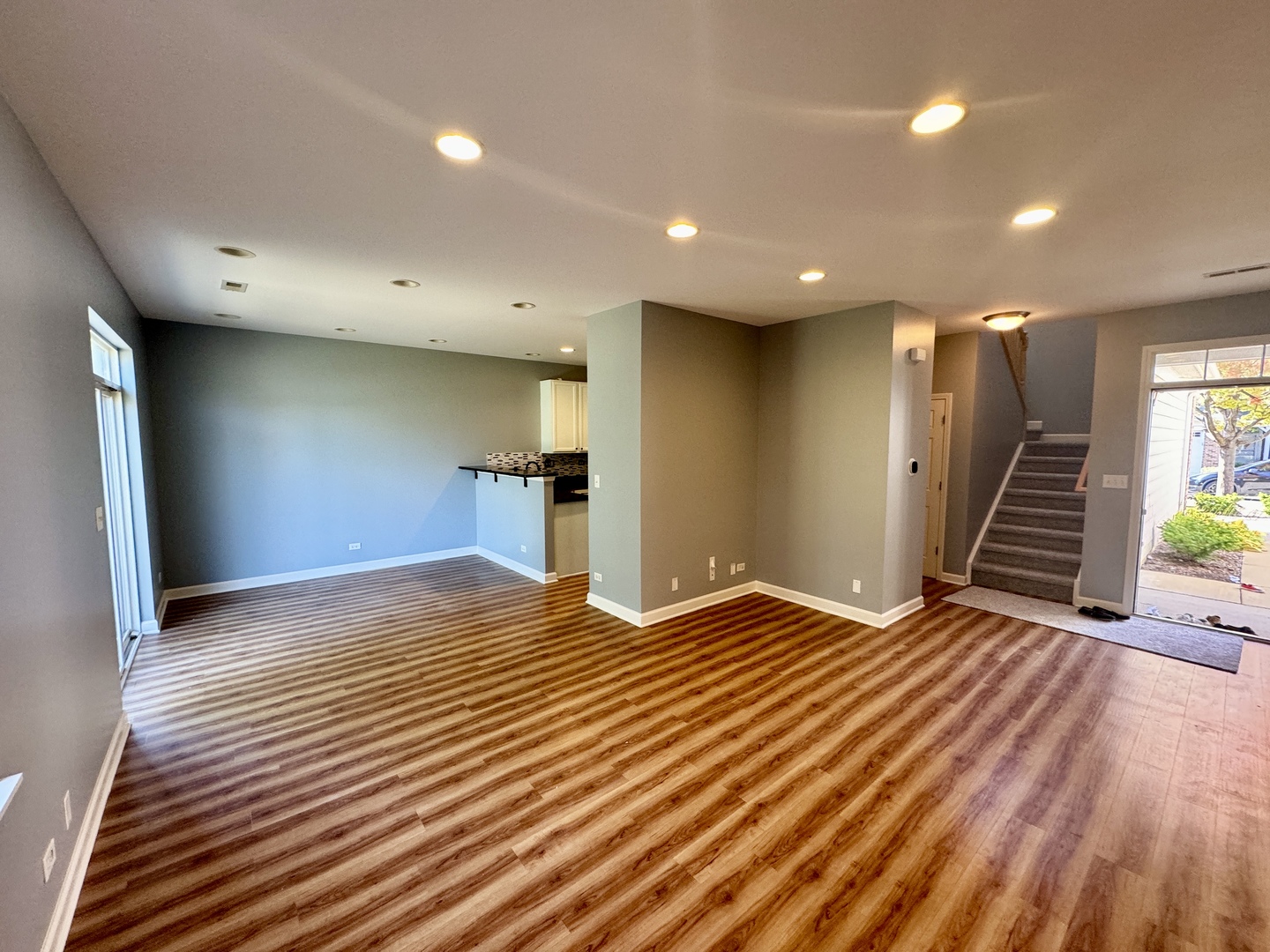 423 Acushnet Street, Unit 423 Elgin, IL 60124 - Photo 3 of 20 a view of an empty room with wooden floor and a ceiling fan