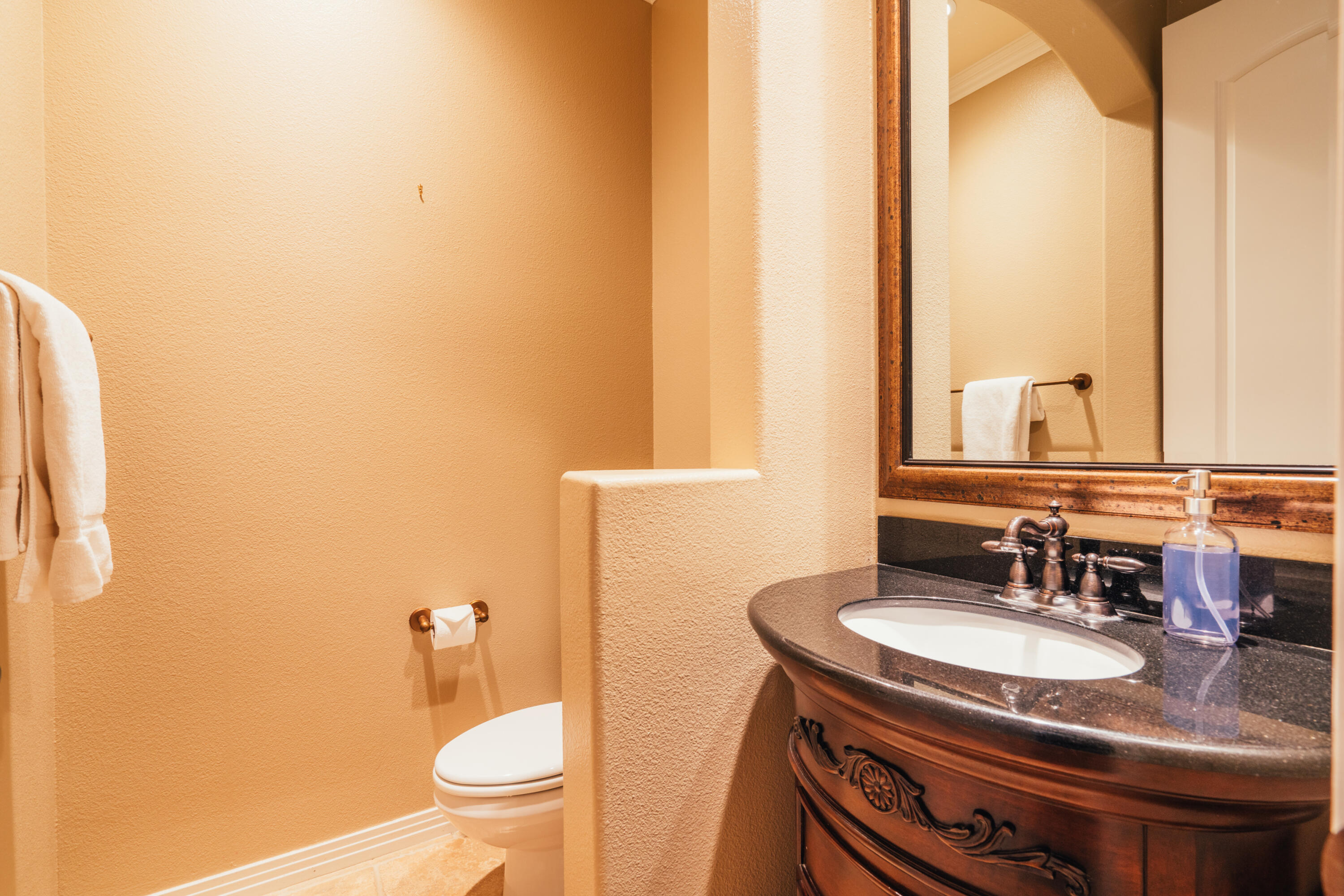 48789 Cascade Street Indio, CA 92201 - Photo 18 of 34 a bathroom with a granite countertop sink toilet and mirror