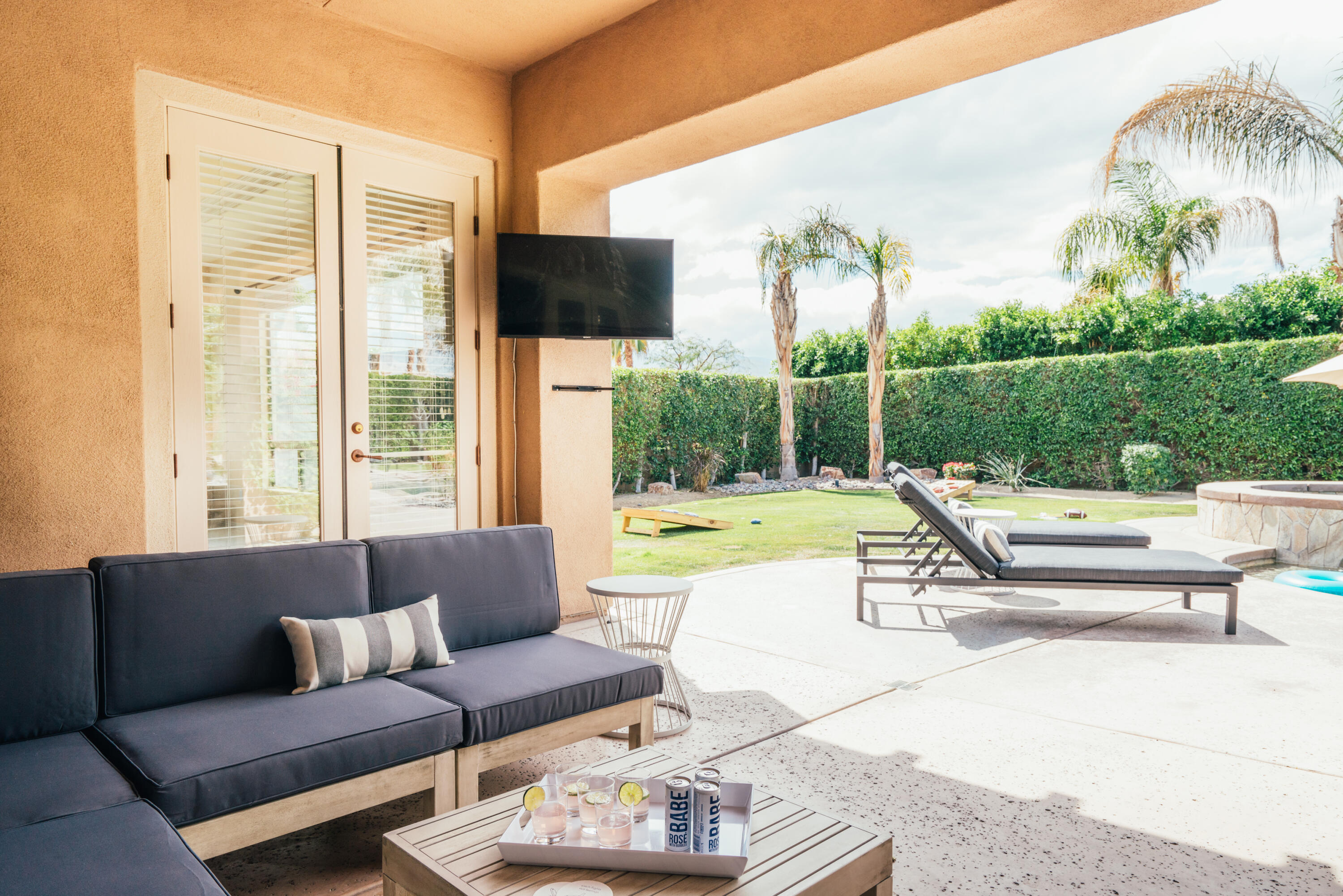 48789 Cascade Street Indio, CA 92201 - Photo 22 of 34 a view of a patio with couches and swimming pool with a yard