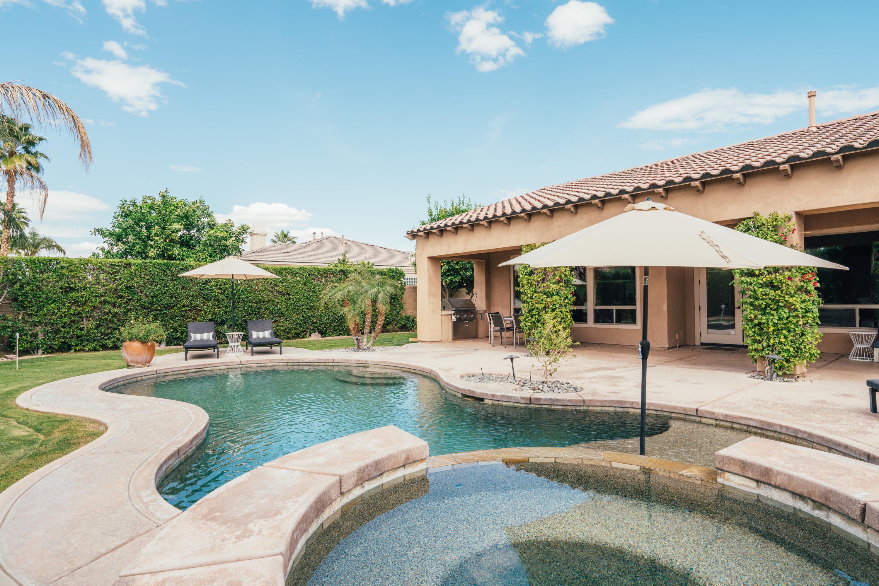 48789 Cascade Street Indio, CA 92201 - Photo 26 of 34 a swimming pool with outdoor seating and yard
