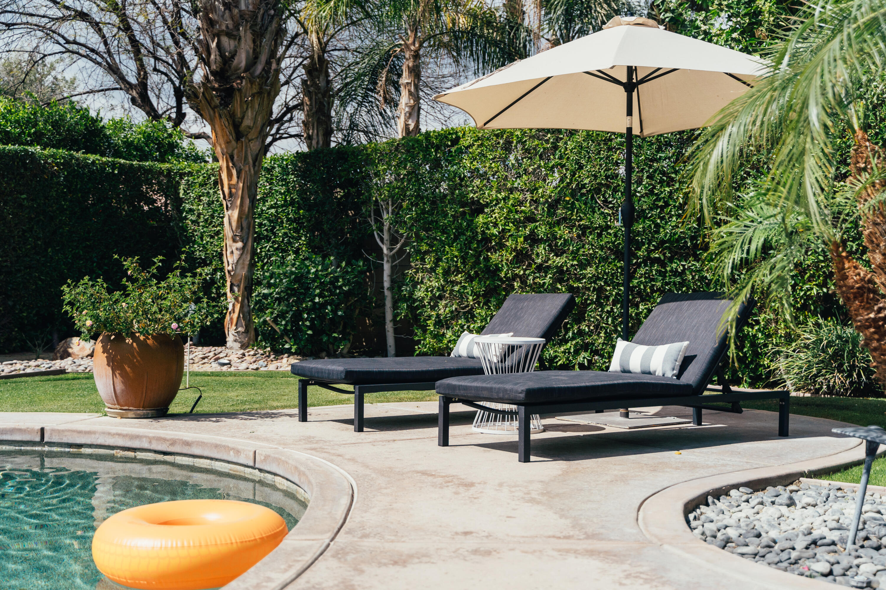 48789 Cascade Street Indio, CA 92201 - Photo 28 of 34 a view of a backyard with sitting area and a garden
