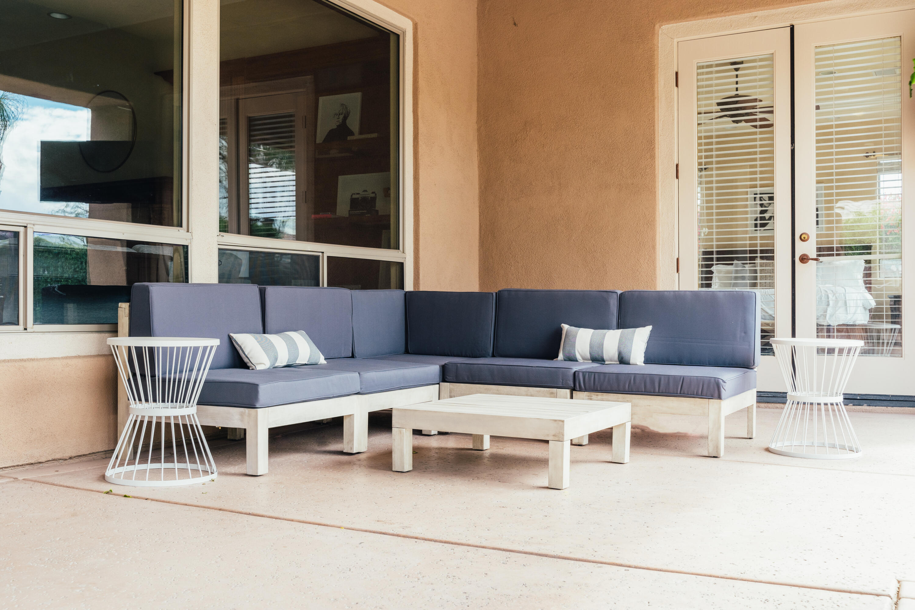 48789 Cascade Street Indio, CA 92201 - Photo 30 of 34 a living room with furniture a flat screen tv and a floor to ceiling window