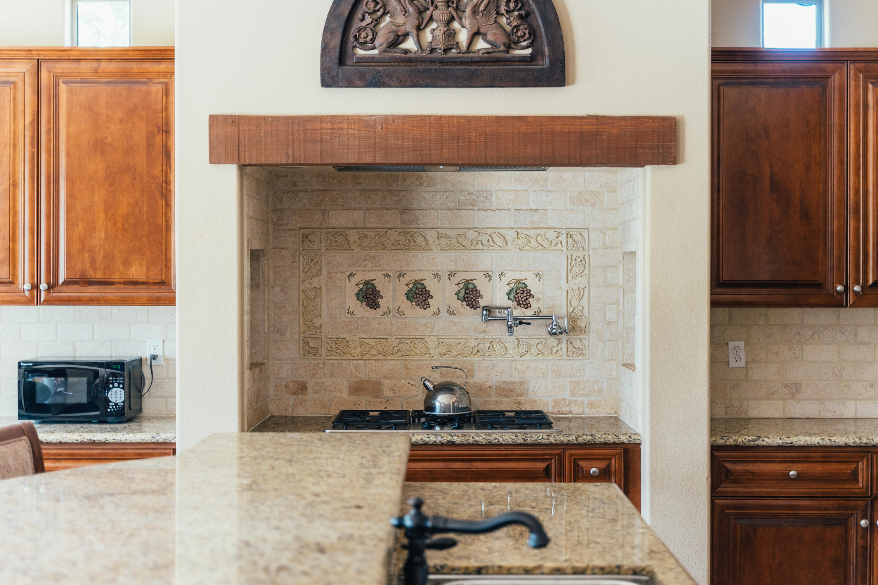 48789 Cascade Street Indio, CA 92201 - Photo 6 of 34 a living room with a stove and a painting on the wall