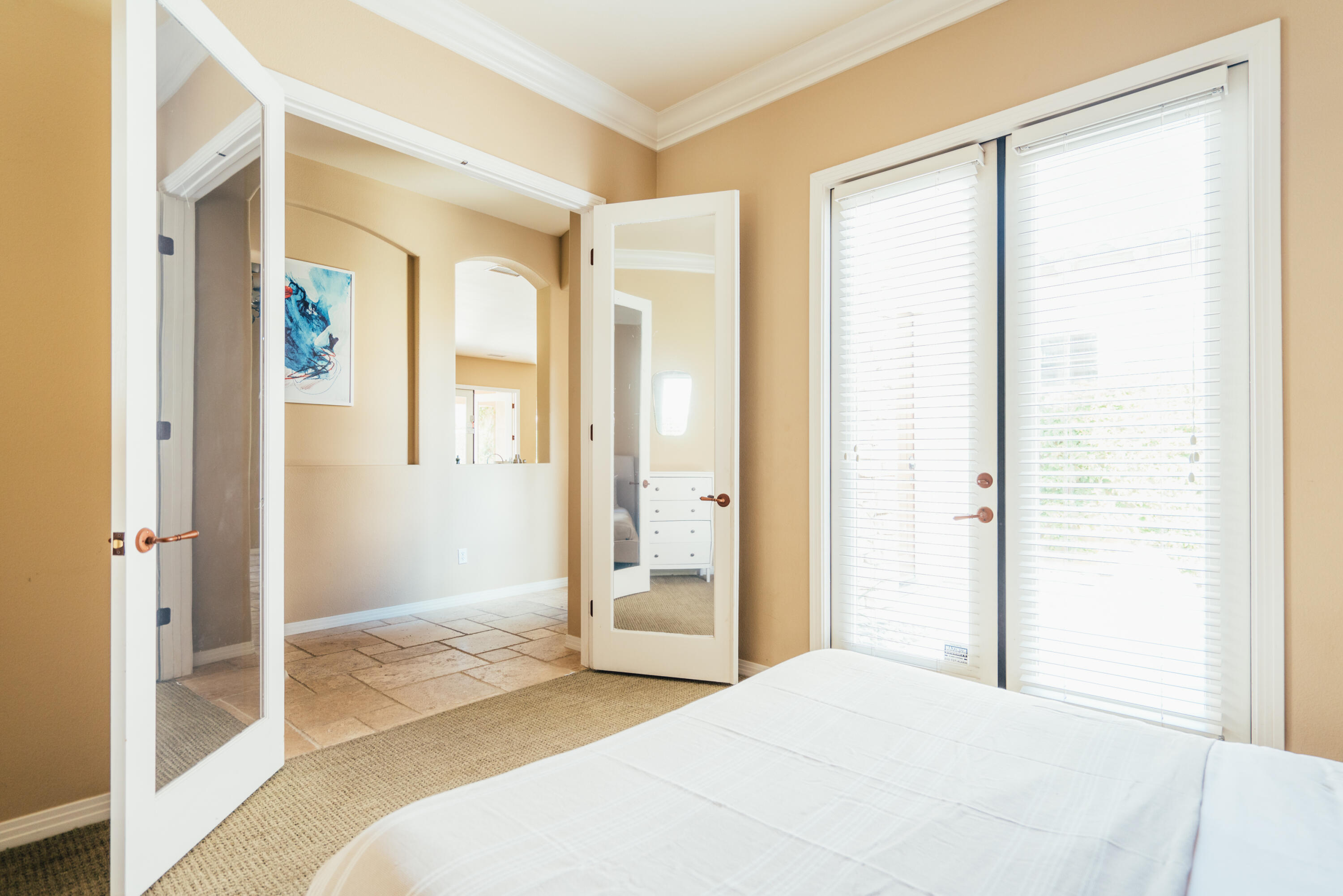 48789 Cascade Street Indio, CA 92201 - Photo 7 of 34 a bedroom with a bed and a large mirror