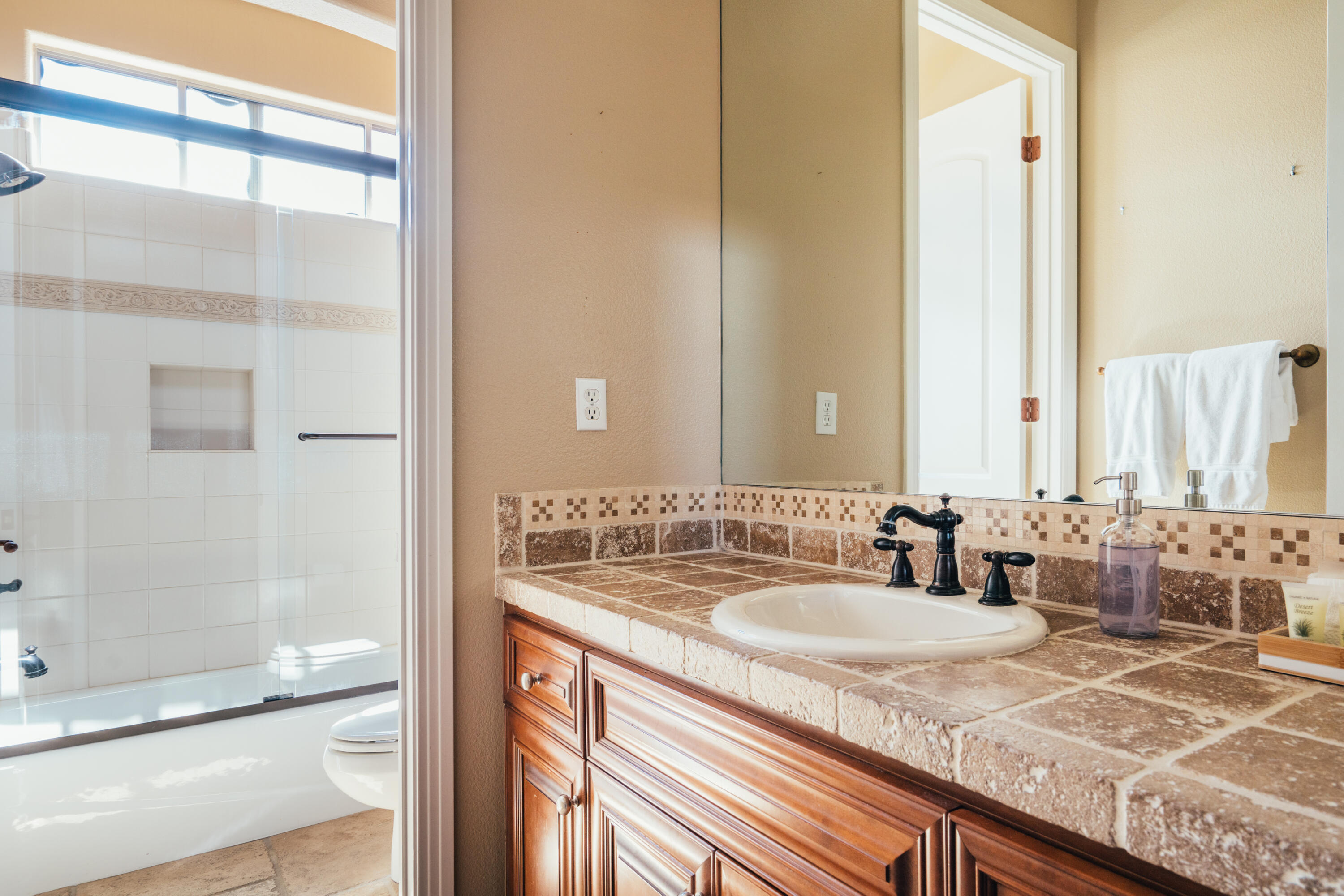 48789 Cascade Street Indio, CA 92201 - Photo 10 of 34 a bathroom with a granite countertop sink and a mirror
