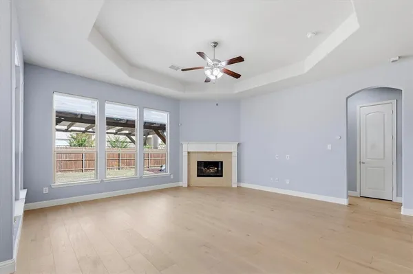 a view of a livingroom with wooden floor a fireplace