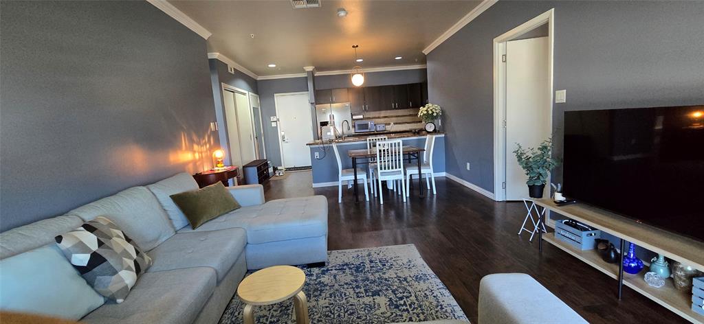 1100 West Trinity Mills Road, Unit 2045 Carrollton, TX 75006 - Photo 8 of 20 Living area featuring dark wood-type flooring, ornamental molding, and recessed lighting