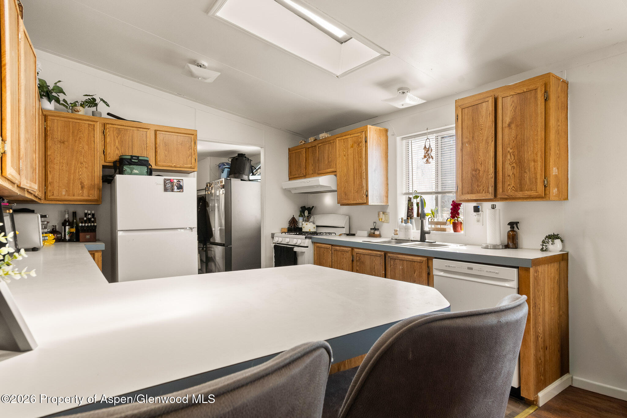301 County Road 334A Rifle, CO 81650 - Photo 13 of 26 a kitchen with stainless steel appliances a refrigerator a sink a stove a oven a dining table and chairs