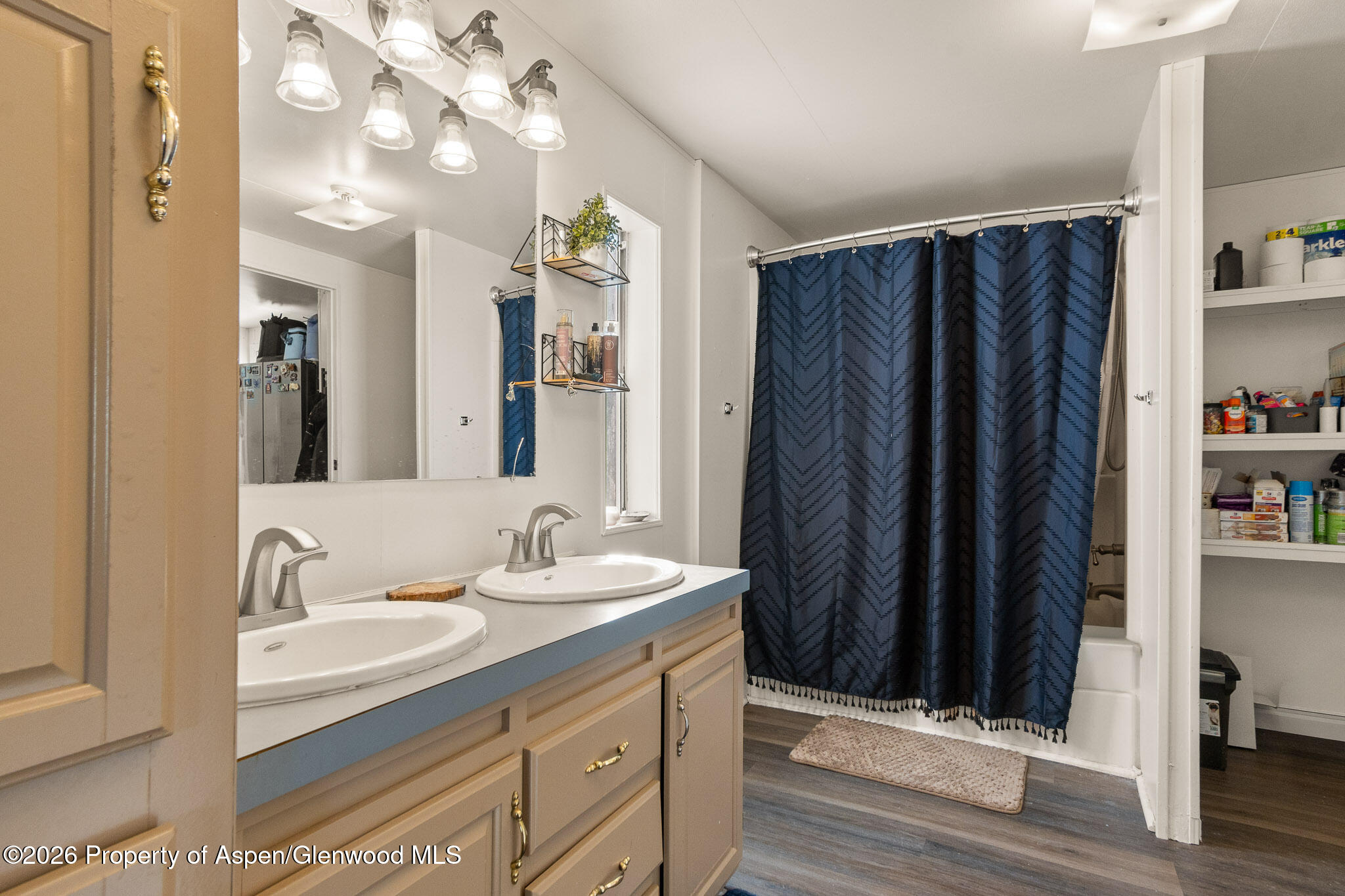 301 County Road 334A Rifle, CO 81650 - Photo 18 of 26 a bathroom with a sink vanity and a mirror