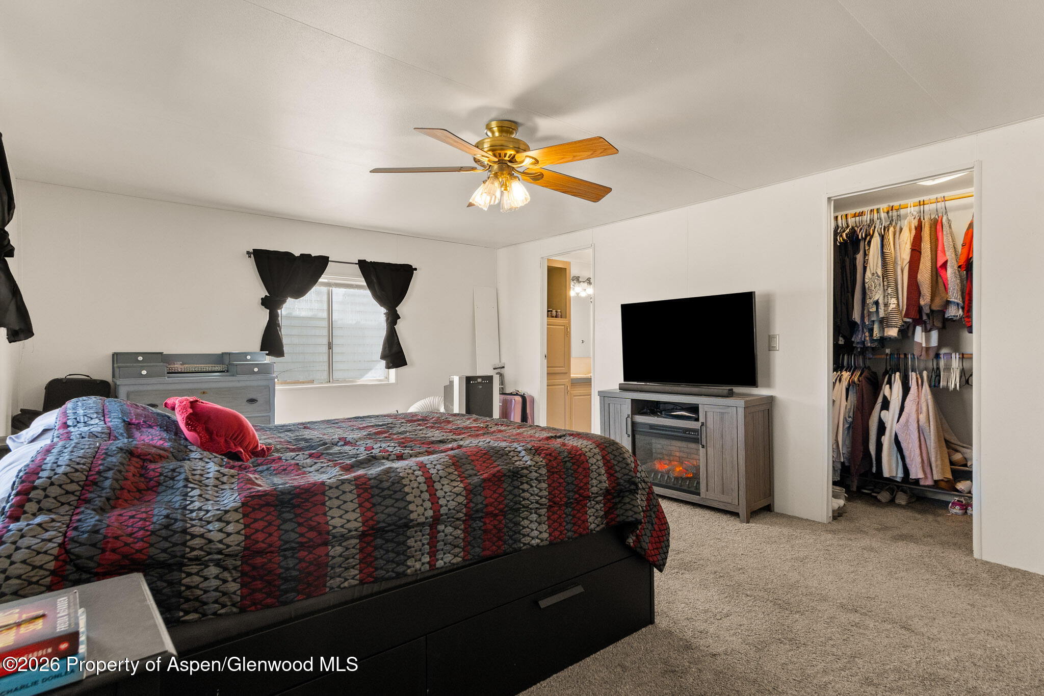 301 County Road 334A Rifle, CO 81650 - Photo 19 of 26 a bedroom with a bed and a flat screen tv