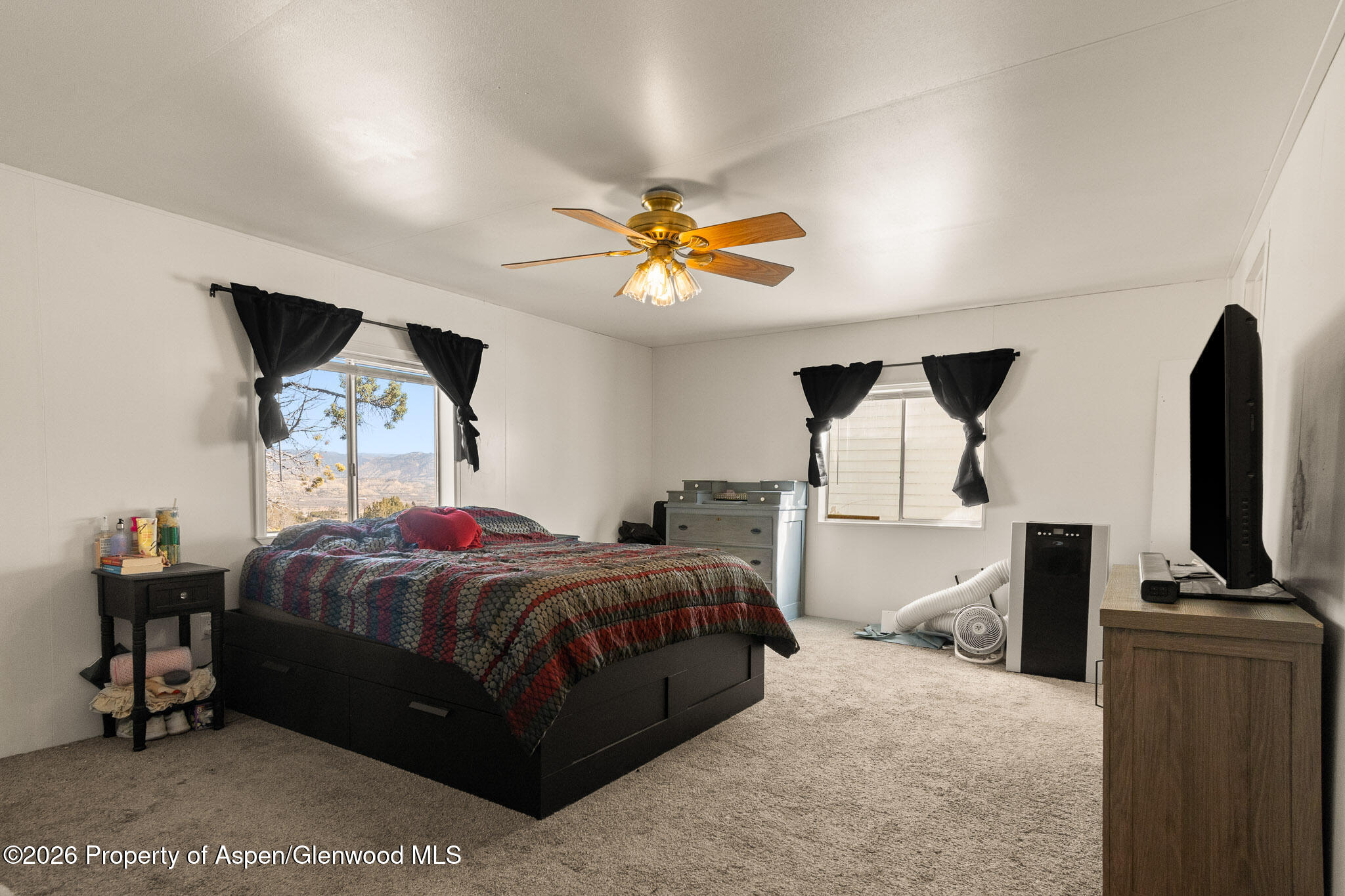 301 County Road 334A Rifle, CO 81650 - Photo 20 of 26 a bedroom with a bed and a flat screen tv