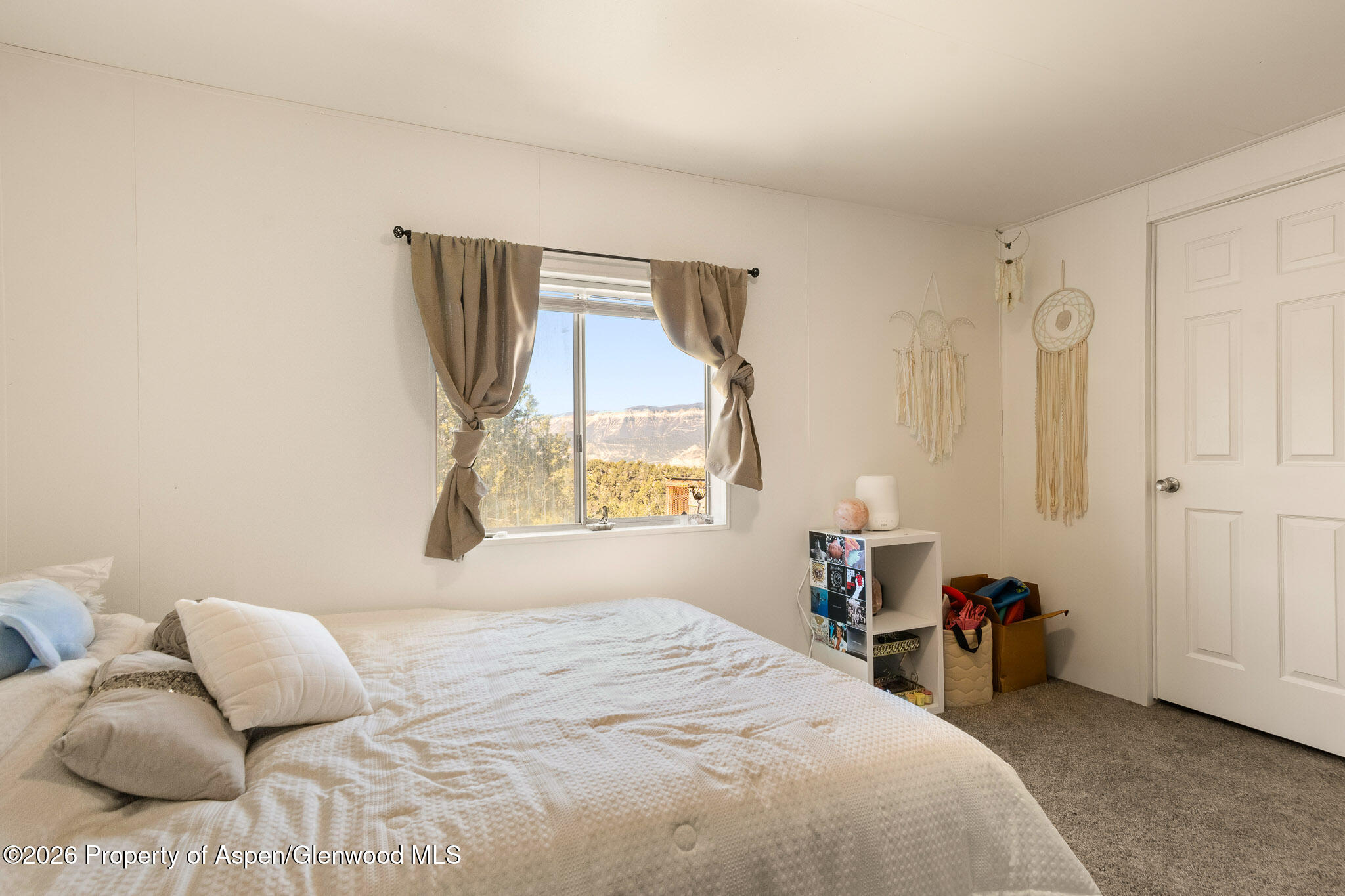 301 County Road 334A Rifle, CO 81650 - Photo 8 of 26 a bedroom with a bed and a window