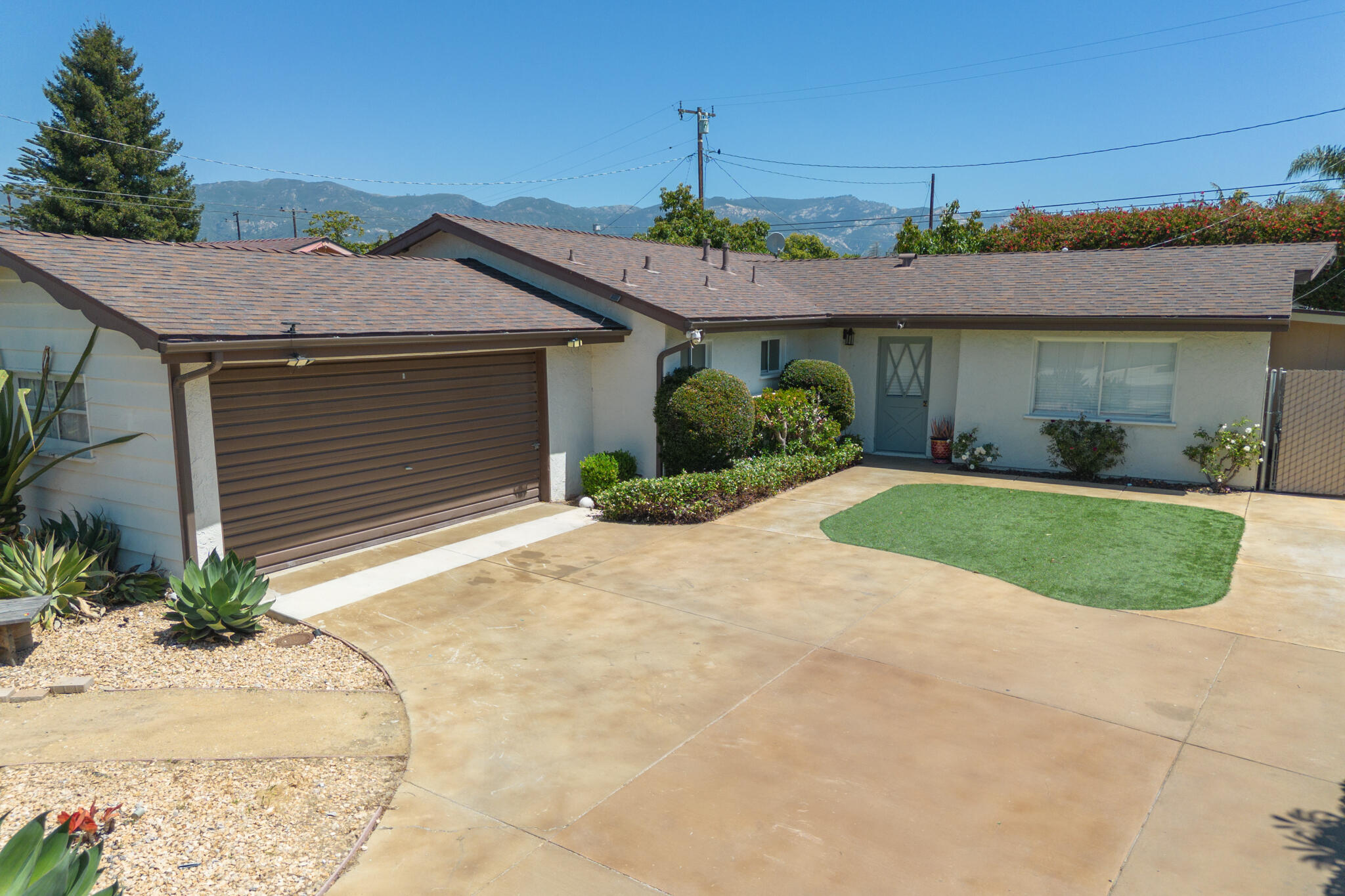 676 San Ramon Drive Santa Barbara, CA 93111 - Photo 3 of 9 a view of a house with a yard and potted plants