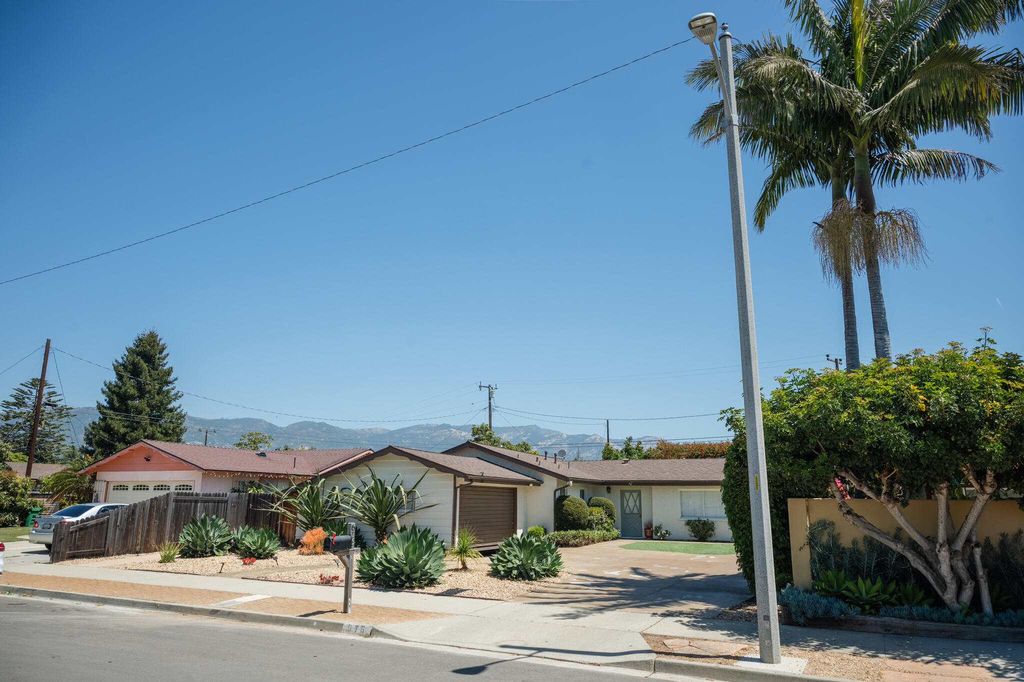 676 San Ramon Drive Santa Barbara, CA 93111 - Photo 9 of 9 a front view of a house with a yard and palm trees