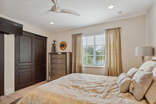 a bedroom with a bed dresser and a window