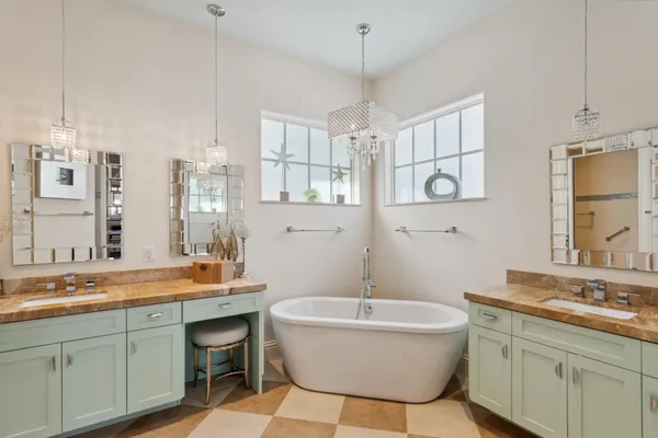 a bathroom with a granite countertop sink mirror bathtub and toilet