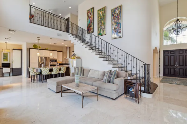 a living room with furniture and a chandelier