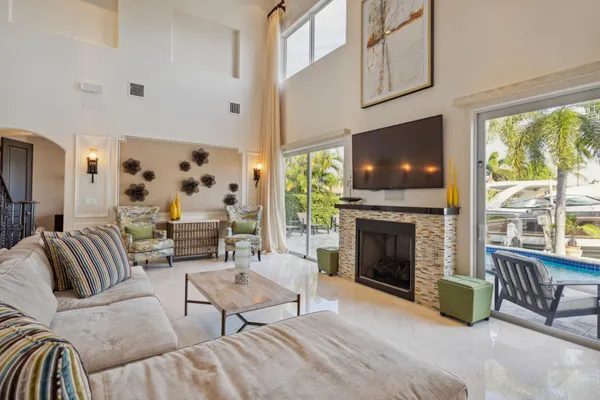 a living room with furniture a fireplace and a flat screen tv