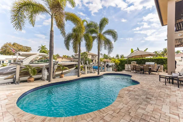 a view of a swimming pool with lawn chairs