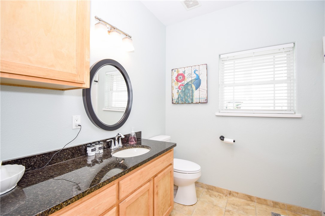 2006 1st Street Bayside, TX 78340 - Photo 26 of 37 a bathroom with a granite countertop sink and a mirror