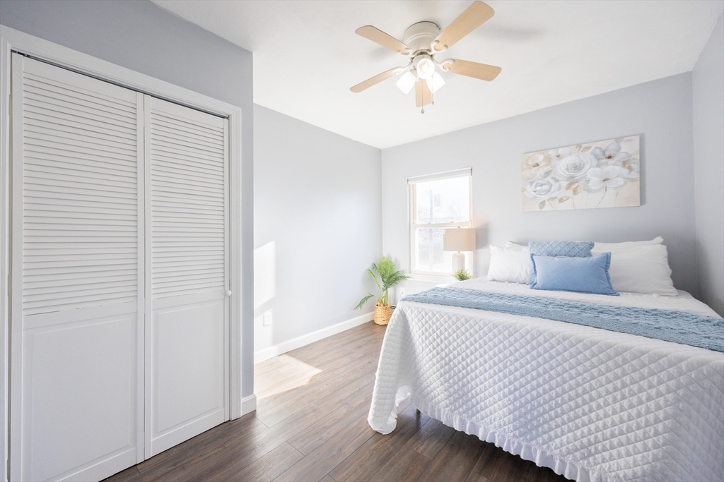 35 Hazel Street, Unit B Attleboro, MA 02703 - Photo 12 of 33 a bedroom with a bed and a chandelier