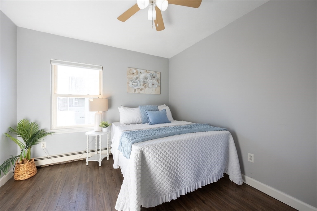 35 Hazel Street, Unit B Attleboro, MA 02703 - Photo 13 of 33 a bedroom with a bed and a potted plant