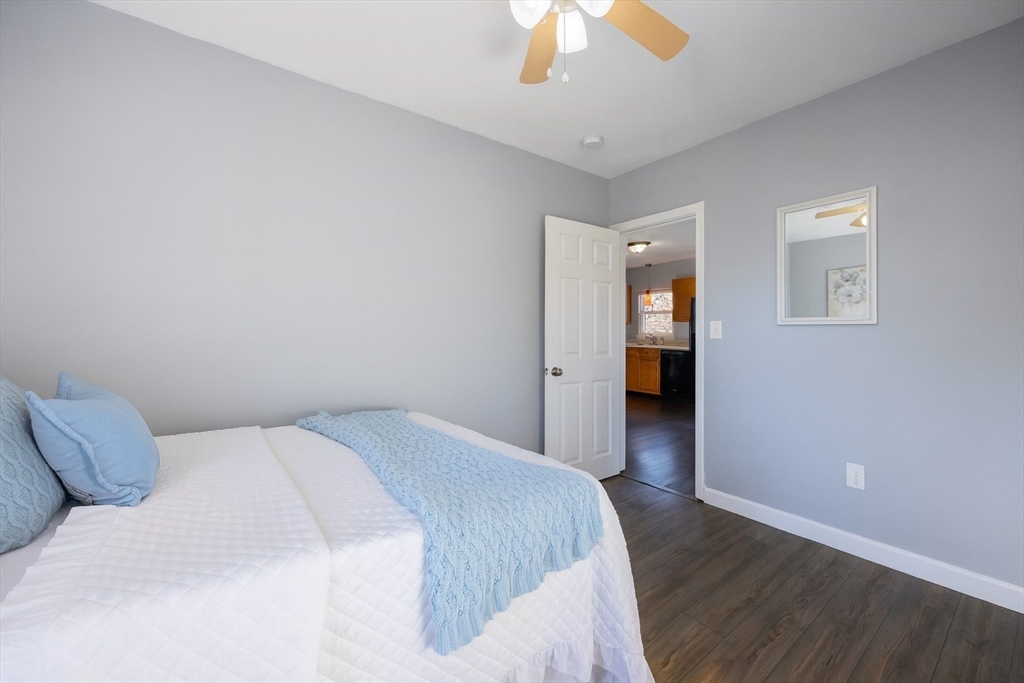 35 Hazel Street, Unit B Attleboro, MA 02703 - Photo 14 of 33 a bedroom with a bed and a chandelier