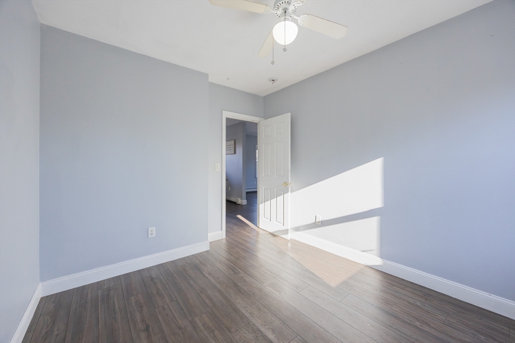 35 Hazel Street, Unit B Attleboro, MA 02703 - Photo 19 of 33 an empty room with wooden floor and door