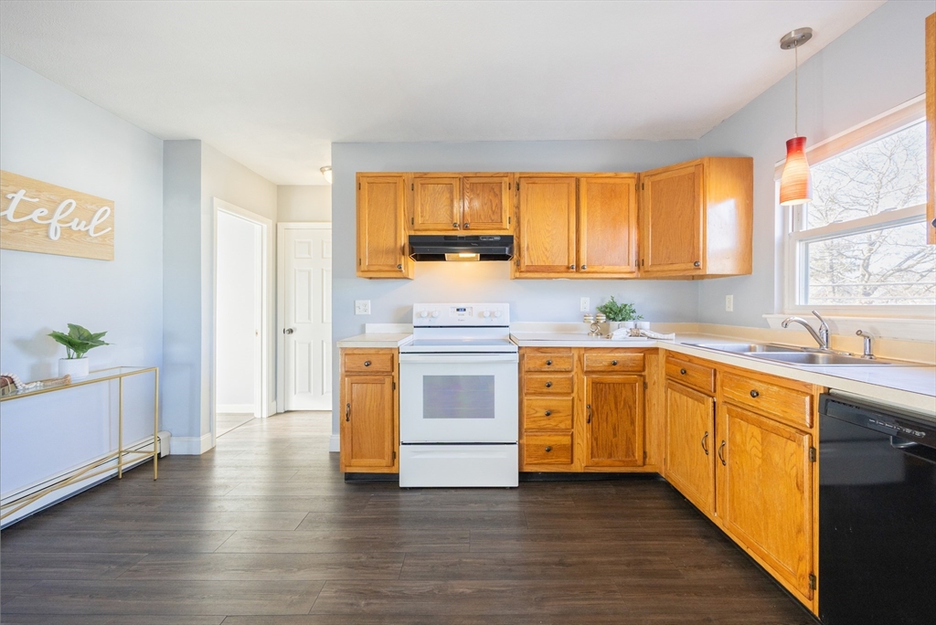 35 Hazel Street, Unit B Attleboro, MA 02703 - Photo 2 of 33 a kitchen with granite countertop wooden floors and white stainless steel appliances