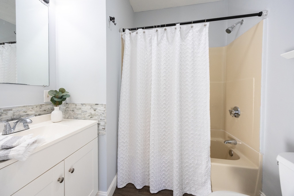 35 Hazel Street, Unit B Attleboro, MA 02703 - Photo 27 of 33 a bathroom with a sink and a mirror