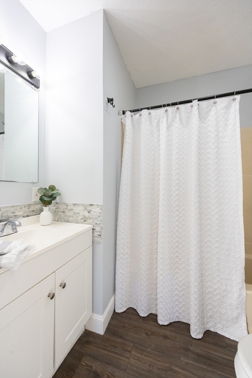 35 Hazel Street, Unit B Attleboro, MA 02703 - Photo 28 of 33 a bathroom with a granite countertop sink and a mirror