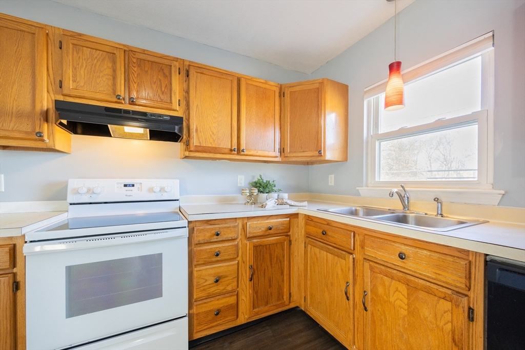 35 Hazel Street, Unit B Attleboro, MA 02703 - Photo 3 of 33 a kitchen with stainless steel appliances granite countertop a sink a stove cabinets and wooden floor