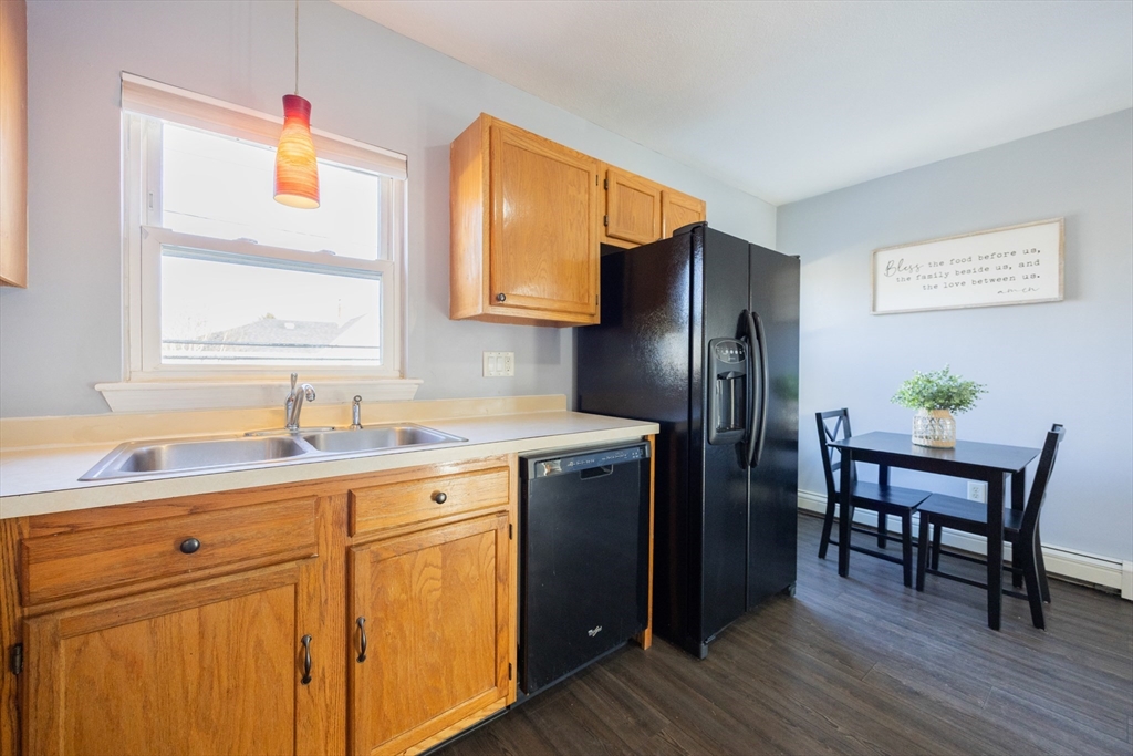 35 Hazel Street, Unit B Attleboro, MA 02703 - Photo 4 of 33 a kitchen with stainless steel appliances a sink cabinets and wooden floor