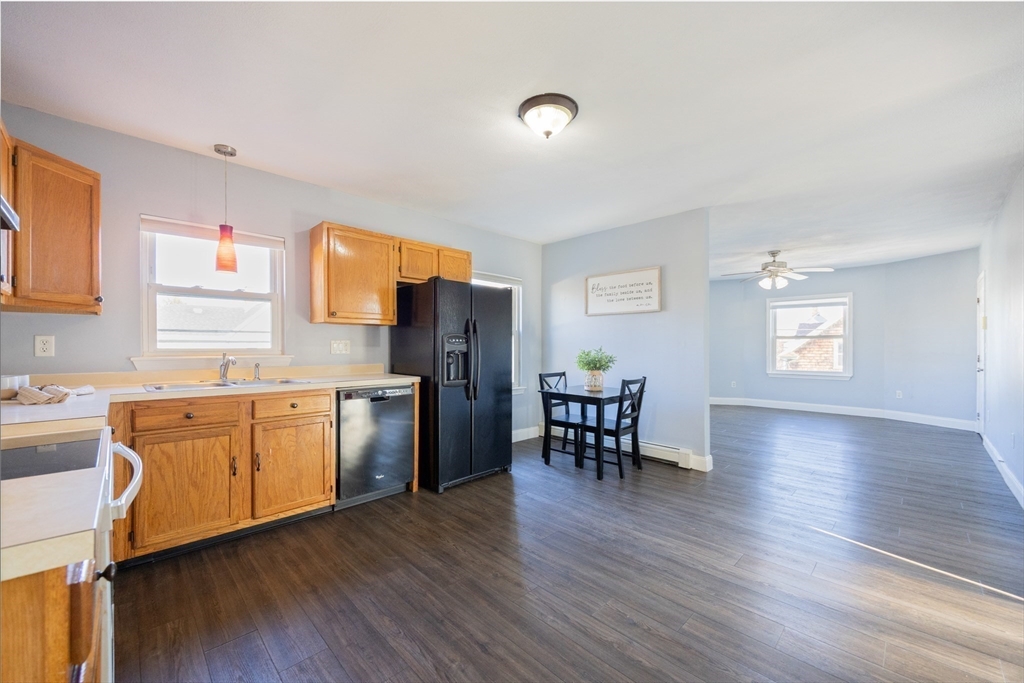 35 Hazel Street, Unit B Attleboro, MA 02703 - Photo 5 of 33 a kitchen with granite countertop appliances cabinets and a wooden floor