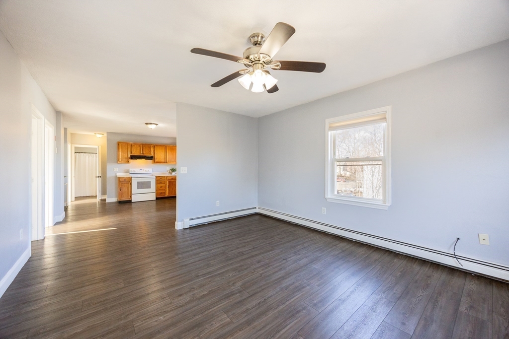 35 Hazel Street, Unit B Attleboro, MA 02703 - Photo 9 of 33 a view of an empty room with wooden floor and a window