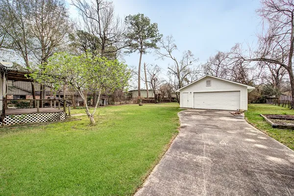 a view of a house with a yard and tree s