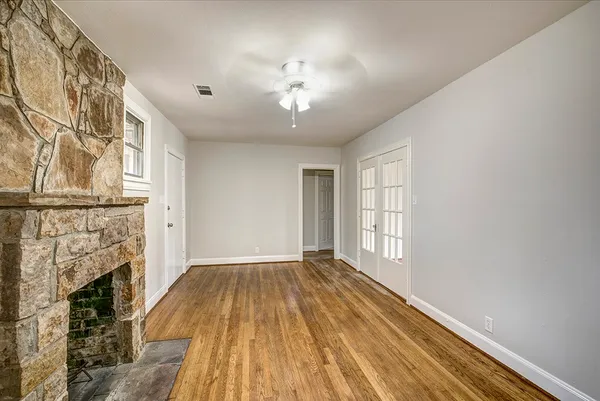 wooden floor in an empty room with a fireplace