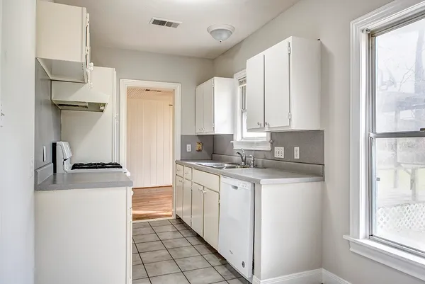 a kitchen with a stove a sink and a refrigerator