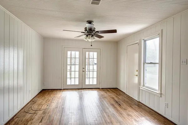 wooden floor in an empty room with a window