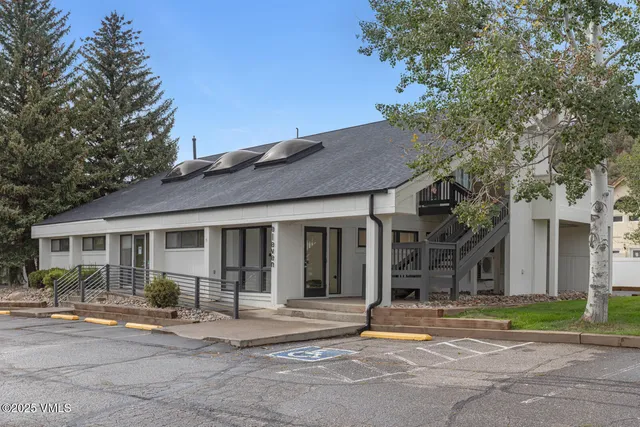 an aerial view of a house with a yard and lake view