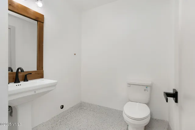 a kitchen with granite countertop a sink stainless steel appliances and cabinets