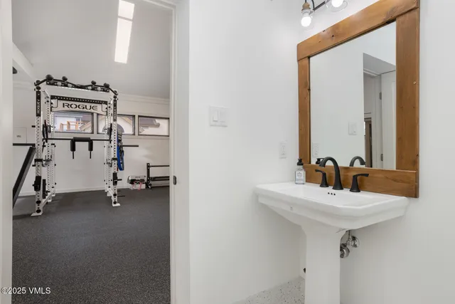 a kitchen with a sink and chairs