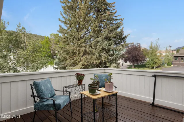 a living room with a couch and a table with wooden floor