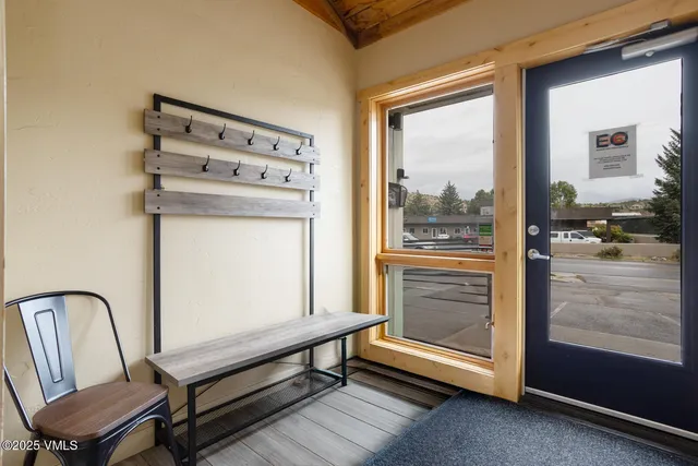 a view of a workspace with furniture and a window