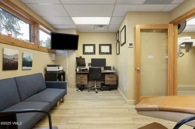 an empty room with wooden floor and cabinet