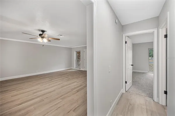 a view of an empty room with wooden floor