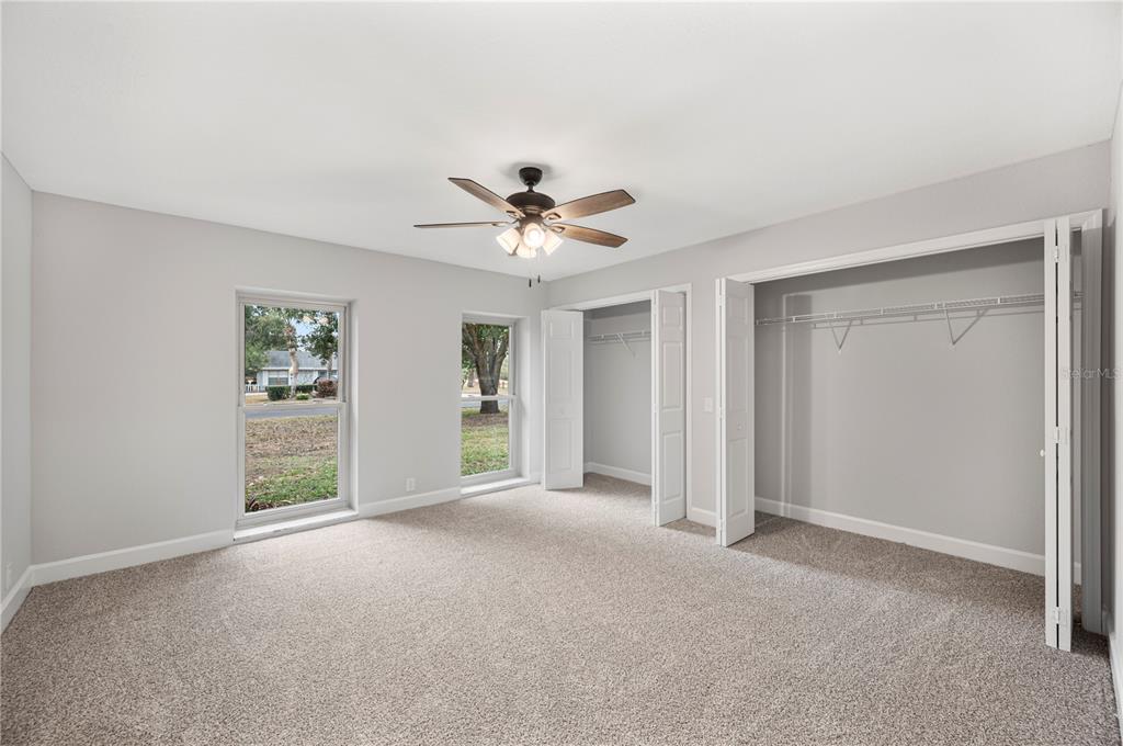 241 Greenfield Road Winter Haven, FL 33884 - Photo 13 of 43 a view of a livingroom with a ceiling fan & windows
